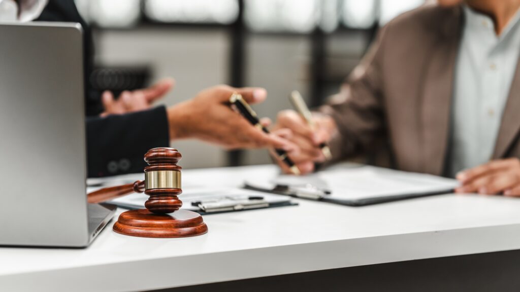 Two discussing businessmen Asian lawyer of Indian descent paying attention to mistakes