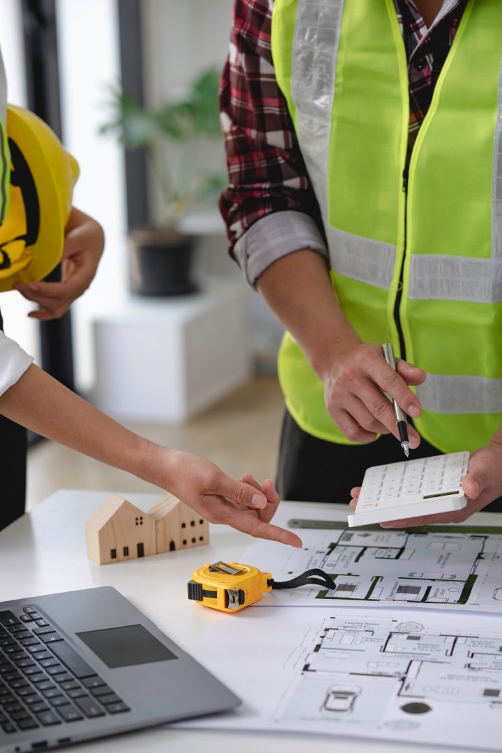 architect and engineer Hand Drawing Plan On Blue Print with architect equipment, Architects discussi